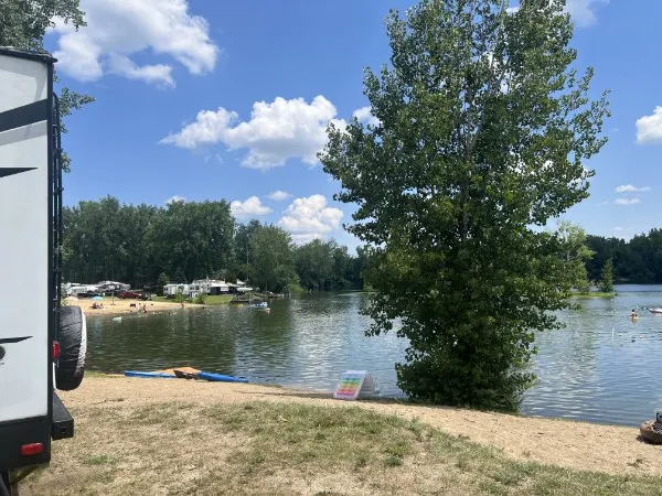 Lake view from a waterfront campsite, beach across the way